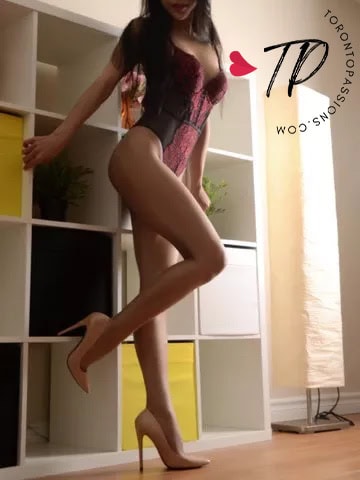 Elegant woman in lingerie and heels posing indoors.