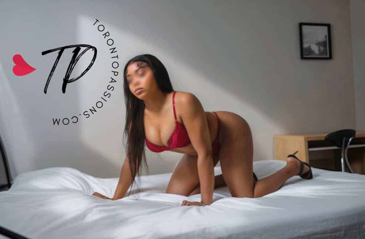 Leilani in red lingerie on bed for Toronto escorts.